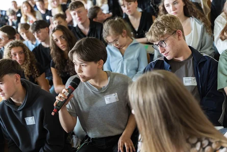 Junge Menschen sitzen im Publikum.